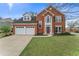 Charming two-story brick home with a well-manicured lawn and a two-car garage at 2500 Grand Manor Ct, Marietta, GA 30068