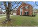 Attractive two-story home with a brick facade, mature trees, and a green lawn at 2500 Grand Manor Ct, Marietta, GA 30068