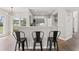 Open kitchen with island seating, wood floors, and sage cabinets at 2500 Grand Manor Ct, Marietta, GA 30068