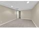 Finished basement showcasing tile flooring, neutral walls, closet, and recessed lighting for a comfortable living space at 3175 Old Jonesboro Rd, Fairburn, GA 30213