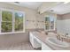 Bathroom with double sinks, marble countertops, and large windows with a view at 3175 Old Jonesboro Rd, Fairburn, GA 30213