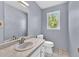 Neutral bathroom with a single sink vanity, and a window over the toilet at 3175 Old Jonesboro Rd, Fairburn, GA 30213