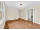 A bright bedroom with hardwood floors, a chandelier, and access to another room at 3175 Old Jonesboro Rd, Fairburn, GA 30213