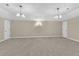 Spacious bonus room featuring neutral walls, carpeting, and lighting fixtures at 3175 Old Jonesboro Rd, Fairburn, GA 30213