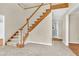 Bright foyer features a staircase with wooden banister and white risers, and ceramic tile flooring at 3175 Old Jonesboro Rd, Fairburn, GA 30213