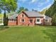 Charming two-story brick home with a large, manicured lawn and classic architectural details at 3175 Old Jonesboro Rd, Fairburn, GA 30213