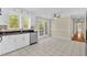 Bright kitchen with white cabinets, stainless steel dishwasher, and French doors to backyard at 3175 Old Jonesboro Rd, Fairburn, GA 30213