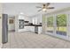 Open kitchen featuring white cabinets, stainless steel appliances, and double doors to outdoor deck at 3175 Old Jonesboro Rd, Fairburn, GA 30213
