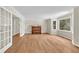 Sunlit living room with hardwood floors, large windows, French doors, and a piano at 3175 Old Jonesboro Rd, Fairburn, GA 30213