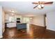 Open-concept living room with hardwood floors seamlessly connects to the kitchen area at 3773 Sarahs Ln, Tucker, GA 30084