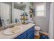Well-lit bathroom with blue vanity and decor at 3557 Bill Gardner Pkwy, Locust Grove, GA 30248