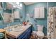 Well-lit bathroom with a solid surface vanity, large mirror, and updated fixtures at 3557 Bill Gardner Pkwy, Locust Grove, GA 30248