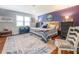 This spacious bedroom features a large bed, a cozy area rug and ample lighting at 3557 Bill Gardner Pkwy, Locust Grove, GA 30248