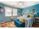Bright bedroom featuring a large window, hardwood floors, and colorful decor at 3557 Bill Gardner Pkwy, Locust Grove, GA 30248