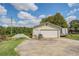 Detached two-car garage with ample parking and storage space, complemented by a wide concrete driveway at 3557 Bill Gardner Pkwy, Locust Grove, GA 30248