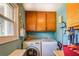 Functional laundry room with storage cabinets and a window at 3557 Bill Gardner Pkwy, Locust Grove, GA 30248