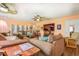 Cozy living room featuring comfortable seating, ceiling fan, and a view of the adjacent rooms at 3557 Bill Gardner Pkwy, Locust Grove, GA 30248