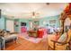 Open-concept living room with hardwood floors, stylish furniture, and a ceiling fan at 3557 Bill Gardner Pkwy, Locust Grove, GA 30248