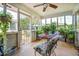 Light-filled sunroom with cozy seating, lush greenery, and serene views, creating a tranquil indoor retreat at 3557 Bill Gardner Pkwy, Locust Grove, GA 30248
