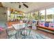 Bright sunroom filled with plants, comfortable seating, and natural light, perfect for relaxation and enjoying nature at 3557 Bill Gardner Pkwy, Locust Grove, GA 30248