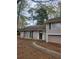 Inviting front entrance with a walkway leading to the front door, complemented by the natural surroundings at 5251 Greenpoint Dr, Stone Mountain, GA 30088