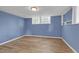 Basement with a cozy ambiance from the light paint and ample natural light from the window at 149 Roy Huie Rd, Riverdale, GA 30274