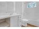Modern bathroom features white cabinets, white tile tub surround, and brushed nickel fixtures at 149 Roy Huie Rd, Riverdale, GA 30274