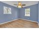 Bedroom boasts lots of light from two windows and ceiling fan to keep you cool and comfortable at 149 Roy Huie Rd, Riverdale, GA 30274