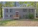 Charming two-story home with a brick facade and a cozy front porch, set amidst lush greenery and mature trees at 149 Roy Huie Rd, Riverdale, GA 30274