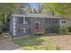 Charming two-story home with a brick facade and a cozy front porch, set amidst lush greenery and mature trees at 149 Roy Huie Rd, Riverdale, GA 30274