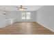 Bright and airy living room featuring hardwood floors, a ceiling fan, and large windows with natural light at 149 Roy Huie Rd, Riverdale, GA 30274