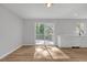 Bright and airy living room featuring hardwood floors, and sliding glass doors to large rear deck at 149 Roy Huie Rd, Riverdale, GA 30274