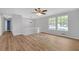 Bright and airy living room featuring hardwood floors, a ceiling fan, and large windows with natural light at 149 Roy Huie Rd, Riverdale, GA 30274