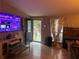 Inviting living room with Roku TV, wood-look floors, and an open doorway at 1506 Ravenel Rd, Conley, GA 30288