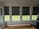 Sunroom with large windows overlooking the green backyard at 1506 Ravenel Rd, Conley, GA 30288