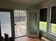 Enclosed sunroom with tiled floor and backyard access at 1506 Ravenel Rd, Conley, GA 30288