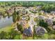 Aerial view of homes in a tranquil neighborhood, surrounded by a serene lake at 4457 Equity Ct, Ellenwood, GA 30294