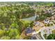 Overhead shot of a serene neighborhood with beautiful homes surrounding a pond, mature trees, and landscaped yards at 4457 Equity Ct, Ellenwood, GA 30294