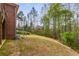 Well-maintained backyard with lush lawn and mature trees, perfect for outdoor activities at 4457 Equity Ct, Ellenwood, GA 30294