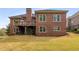 Expansive backyard featuring a well-maintained lawn, patio area and mature trees at 4457 Equity Ct, Ellenwood, GA 30294