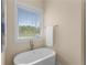 Bright bathroom featuring a modern soaking tub, ample natural light, and stylish fixtures at 4457 Equity Ct, Ellenwood, GA 30294