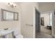 Accessible bathroom featuring a sink, toilet, and tiled shower with a bench at 4457 Equity Ct, Ellenwood, GA 30294