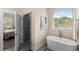 Serene bathroom showcasing a modern soaking tub, separate shower, and ample natural light creating a spa-like experience at 4457 Equity Ct, Ellenwood, GA 30294