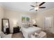 Inviting bedroom with a comfortable bed, soft lighting, a full length mirror, and neutral color scheme at 4457 Equity Ct, Ellenwood, GA 30294