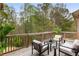 Relaxing deck area with comfortable seating and a view of the lush, wooded backyard at 4457 Equity Ct, Ellenwood, GA 30294
