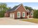 Lovely brick home with a two-car garage and a pristine, well-maintained lawn at 4457 Equity Ct, Ellenwood, GA 30294