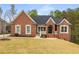 Charming brick home with well-manicured lawn and classic architectural details at 4457 Equity Ct, Ellenwood, GA 30294