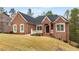 Beautiful brick home featuring a manicured lawn and inviting entrance at 4457 Equity Ct, Ellenwood, GA 30294