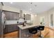 Contemporary kitchen boasts granite countertops, stainless steel appliances, and an island with barstools, ideal for casual dining at 4457 Equity Ct, Ellenwood, GA 30294