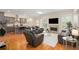Bright living room with a fireplace, skylight, and open-concept design, seamlessly connecting to the modern kitchen at 4457 Equity Ct, Ellenwood, GA 30294